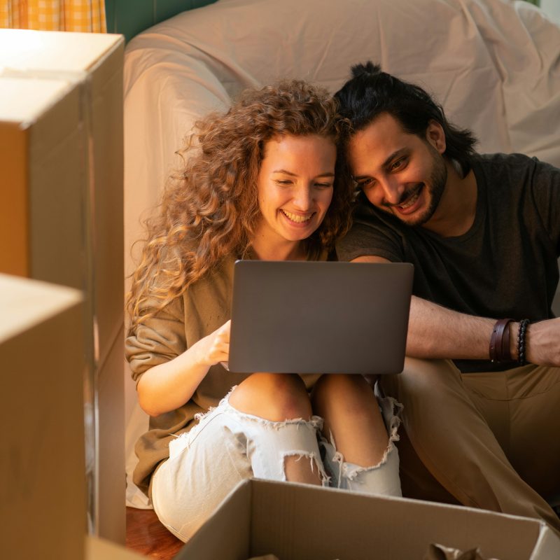 couple looking happily at a computer screen. Betrayal Trauma Therapy Utah. therapy utah. Empower You Therapy. therapist draper. empowering you therapy. faith transition therapist utah. counseling draper. marriage counseling draper utah. emdr therapist utah. postpartum therapist utah. couples therapy utah