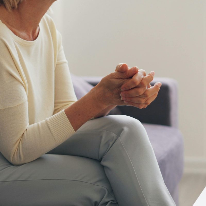 Woman clasping her hands together while sitting. Betrayal Trauma Therapy Utah. therapy utah. Empower You Therapy. therapist draper. empowering you therapy. faith transition therapist utah. counseling draper. marriage counseling draper utah. emdr therapist utah. postpartum therapist utah. couples therapy utah